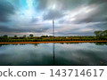 Pastoral view features water display and infrastructure present 143714617