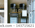 HVAC Air Conditioning Units and Metal Ductwork Mounted on Building Exterior Wall 143715621