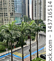 Tropical palms border city streets and modern high-rise facades under soft natural daylight. 143716514