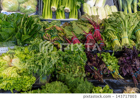 Fresh Green Vegetables And Herbs Display At Market Stall With Lettuce And Swiss Chard 143717803