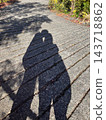 Two shadows cast on the ground 143718862