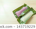 White and purple mochi made from ginger lily leaves and the blank space on the left. 143719229