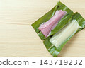 A bird's-eye view of the white and purple mochi of ginger lily leaves and the surrounding negative space. 143719232