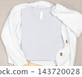 Heather grey folded t-shirt mockup on white knitted cardigan, template for print on demand 143720028
