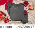 Blank dark grey folded sweatshirt mockup near Christmas decor, copy space. Holiday apparel flat lay 143720037