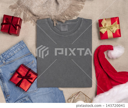 Washed grey t-shirt mockup near Christmas decor, folded crewnwck flat lay. Holiday template Washed grey t-shirt mockup near Christmas decor, folded crewnwck flat lay. Holiday template 143720041
