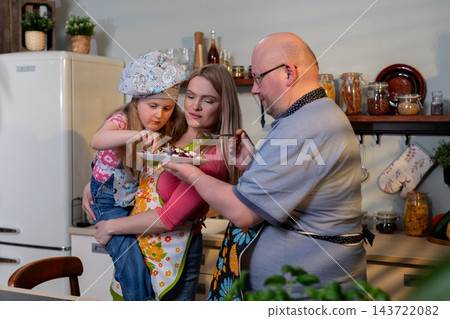 Elderly individual guides young one in culinary skills, Senior family patriarch shares traditional cooking techniques with young descendant in warm rustic environment Elderly individual guides young one in culinary skills, Senior family patriarch shares traditional cooking techniques with young descendant in warm rustic environment 143722082