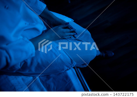 Gentle grip on pillow amid soothing blue lighting and textures. Peaceful moments captured with hands gripping pillow under calm blue illumination and tactile details Gentle grip on pillow amid soothing blue lighting and textures. Peaceful moments captured with hands gripping pillow under calm blue illumination and tactile details 143722175