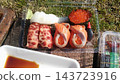 Enjoying a sushi platter purchased at the market outdoors. 143723916