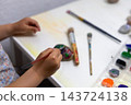 Creative Children Crafting and Painting Pebbles at Home or School. 143724138