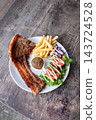 Grilled T-Bone Pork Chop with French Fries and Salad 143724528