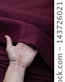 Hand Holding Burgundy Wine Red Linen Fabric Edge 143726021