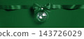 Wide panoramic Christmas and New Year web banner with emerald green satin bow, ribbon and glass ornament, top view. Festive concept with copy space for holiday advertising and website headers 143726029