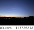 A landscape of the twilight sky and the silhouette of mountains. 143726218