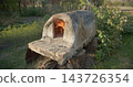 Outdoor wood-fired clay oven heating up for cooking 143726354