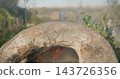 Traditional clay oven burning wood for cooking outdoors 143726356
