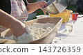 Woman baking bread kneading dough with flour 143726359