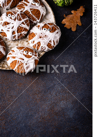 Spooky Halloween mummy cookies with eyes Spooky Halloween mummy cookies with eyes 143726411