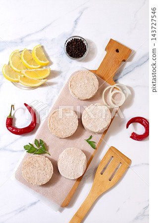 Frozen raw patties for quick preparation made from ground beef and pork featuring onion, tomato, lemon, garlic, recipe for delicious schnitzels and beef steaks, menu options for cafe or restaurant, Frozen raw patties for quick preparation made from ground beef and pork featuring onion, tomato, lemon, garlic, recipe for delicious schnitzels and beef steaks, menu options for cafe or restaurant, 143727546