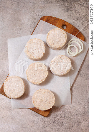 Frozen raw patties for quick preparation made from ground beef and pork featuring onion, tomato, lemon, garlic, recipe for delicious schnitzels and beef steaks, menu options for cafe or restaurant, Frozen raw patties for quick preparation made from ground beef and pork featuring onion, tomato, lemon, garlic, recipe for delicious schnitzels and beef steaks, menu options for cafe or restaurant, 143727549