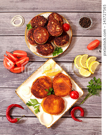 Homemade patties made from a variety of minced meats, seasoned with onion, tomato, lemon, garlic, and pepper , recipe for appetizing schnitzels and beefsteaks, banner for fastfood establishment. 143727565