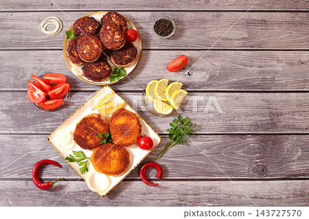 Homemade patties made from a variety of minced meats, seasoned with onion, tomato, lemon, garlic, and pepper , recipe for appetizing schnitzels and beefsteaks, banner for fastfood establishment. Homemade patties made from a variety of minced meats, seasoned with onion, tomato, lemon, garlic, and pepper , recipe for appetizing schnitzels and beefsteaks, banner for fastfood establishment. 143727570