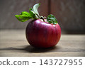 Ripe red apple close-up with sun rays and apple orchard in the 143727955