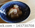 Simmered daikon radish with minced meat. A Japanese simmered dish served in a blue bowl. 143730708