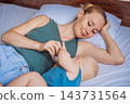 Infant feeding at the breast while mother rests beside him. 143731564