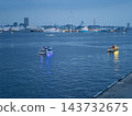 A harbor scene showing a sightseeing boat sailing through Yokohama Port at dusk, along with wind power generation facilities. A harbor scene showing a sightseeing boat sailing through Yokohama Port at dusk, along with wind power generation facilities. 143732675