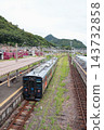 A JR Kyushu YC1 series diesel railcar departing from Arita Station. 143732858