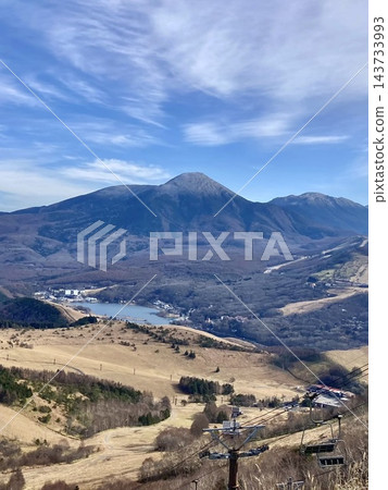 Lake Shirakaba and Mount Tateshina floating against the blue sky as seen from Mount Kurumayama, a plateau landscape transitioning from autumn to winter. Lake Shirakaba and Mount Tateshina floating against the blue sky as seen from Mount Kurumayama, a plateau landscape transitioning from autumn to winter. 143733993