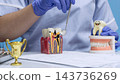 Dental Caries and Endodontic Treatment Education with Dentist Examining Infected Tooth Model and Healthy Teeth 143736269