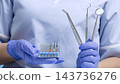 Dentist Holding Professional Endodontic Files and Dental Instruments for Root Canal Treatment and Oral Healthcare Procedures 143736276