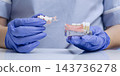 Dentist Demonstrating Removable Partial Denture Placement on Lower Jaw Model for Missing Teeth Replacement and Prosthetic Care 143736278