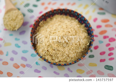 nutritional yeast in a patterned bowl on a table nutritional yeast in a patterned bowl on a table 143737597
