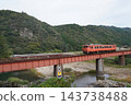 A rural landscape featuring a local train running along the Yamaguchi Line in autumn and a railway bridge, October. A rural landscape featuring a local train running along the Yamaguchi Line in autumn and a railway bridge, October. 143738488
