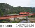 A rural landscape featuring a local train running along the Yamaguchi Line in autumn and a railway bridge, October. A rural landscape featuring a local train running along the Yamaguchi Line in autumn and a railway bridge, October. 143738489
