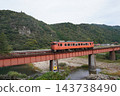 A rural landscape featuring a local train running along the Yamaguchi Line in autumn and a railway bridge, October. A rural landscape featuring a local train running along the Yamaguchi Line in autumn and a railway bridge, October. 143738490