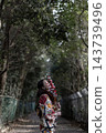 A woman in a kimono walking in nature 143739496