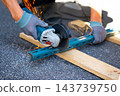 Worker cutting metal with many sharp sparks using equipments to cut iron 143739750