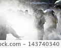 Visitors shrouded in mist spewing from the ground embedded in the pathways of the Osaka-Kansai Expo. 143740340
