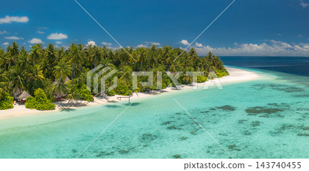 Panoramic lush green tropical island fringed vivid turquoise lagoon powdery shore reef wide bright. Nature landscape scenic print. Exotic paradise fine art Panoramic lush green tropical island fringed vivid turquoise lagoon powdery shore reef wide bright. Nature landscape scenic print. Exotic paradise fine art 143740455