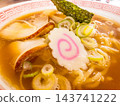 A close-up of Chinese noodles, reminiscent of the Naruto whirlpools. 143741222