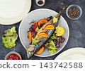 Gourmet baked mackerel with orange and mandarin 143742588