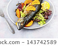 Whole baked mackerel with fresh citrus slices 143742589