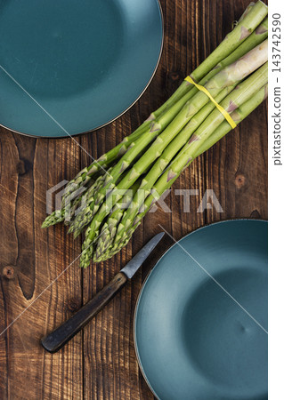 Healthy organic green asparagus for cooking Healthy organic green asparagus for cooking 143742590