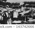 Old photograph: 1923, Tokyo. Temporary housing for disaster victims built in the Imperial Palace Outer Garden (Imperial Palace Plaza) immediately after the Great Kanto Earthquake. 143742666