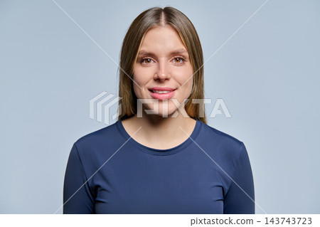 Smiling young woman close up portrait on grey background studio Smiling young woman close up portrait on grey background studio 143743723