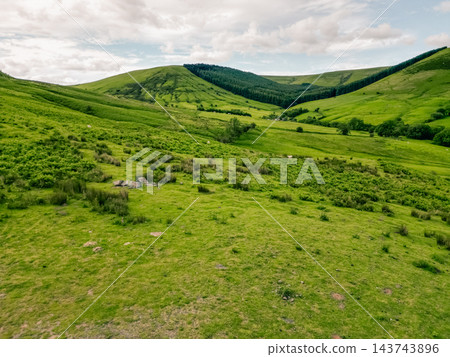 Aerial view of a scenic mountain valley with a winding road through the rugged landscape of Brecon Beacons National Park in Wales, United Kingdom Powys, Wales - 28 August 2026. Aerial view of a scenic mountain valley with a winding road through the rugged landscape of Brecon Beacons National Park in Wales, United Kingdom Powys, Wales - 28 August 2026. 143743896